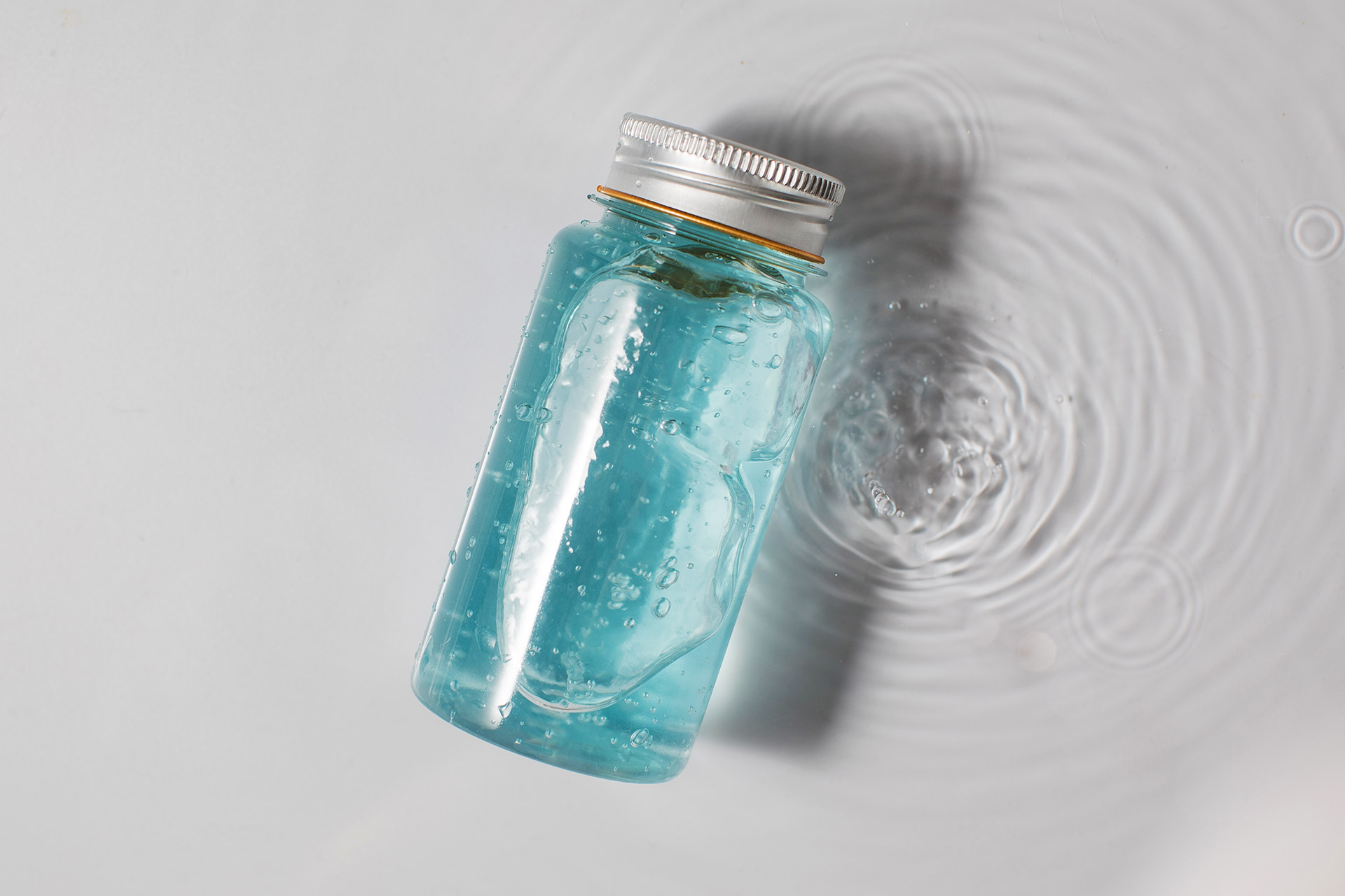 bottle-of-blue-gel-skincare-product-on-white-water-2022-01-26-16-15-55-utc