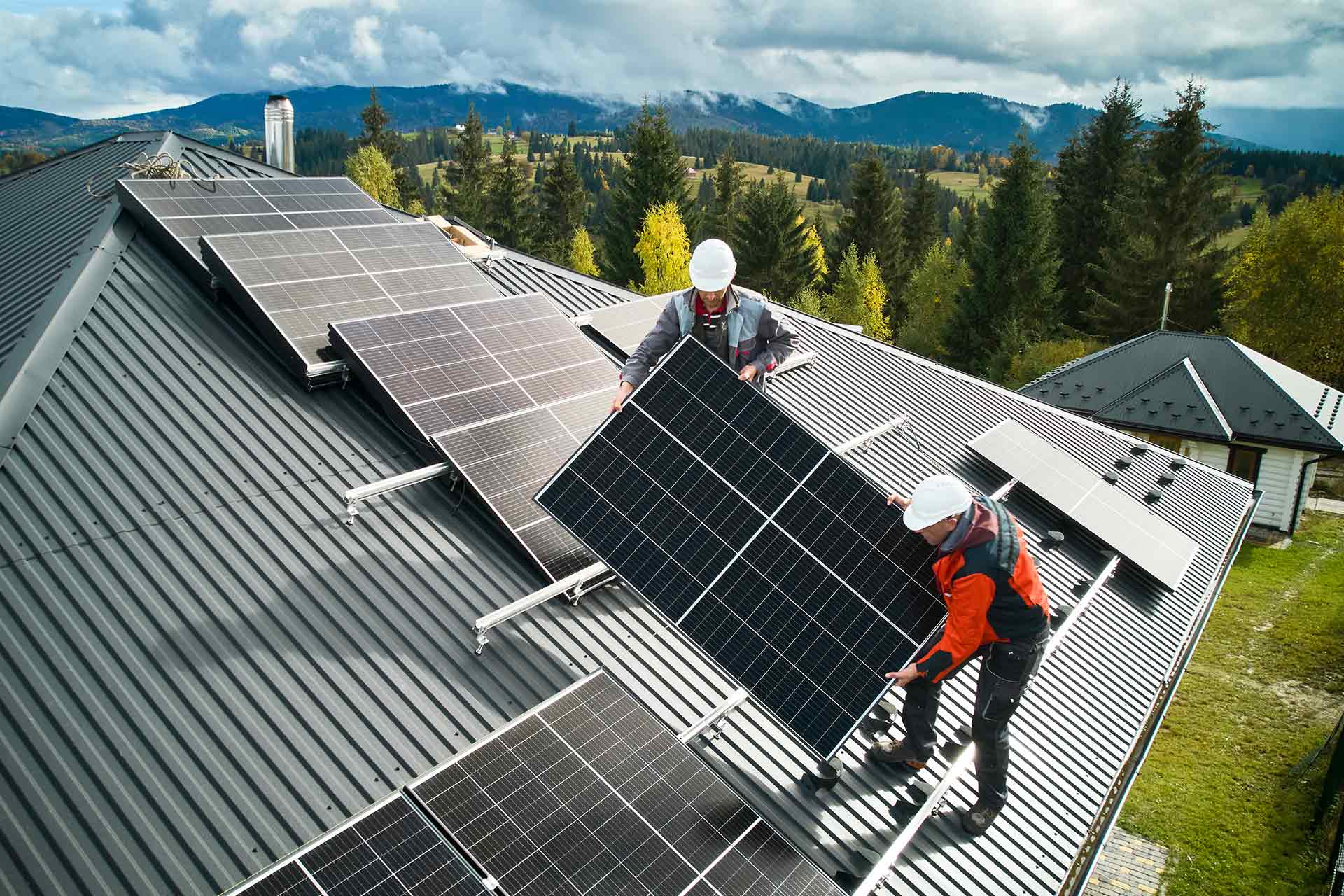workers-installing-solar-panels-on-a-roof-of-house